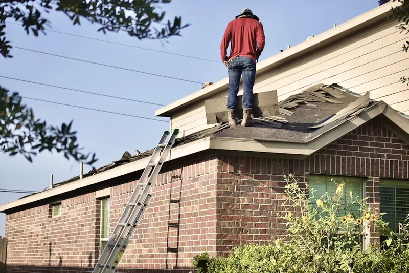 Professional roofer working on a residential roof in Layhill Village